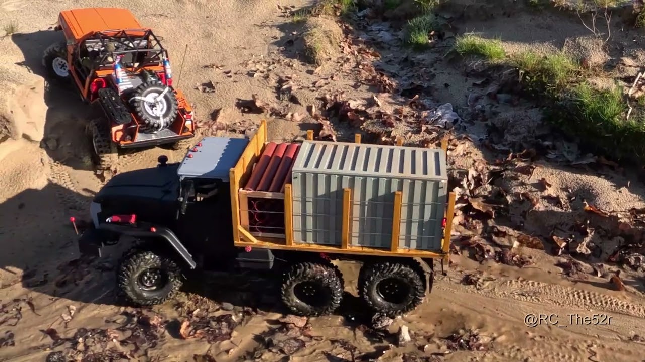Three different trucks on the path at the beach