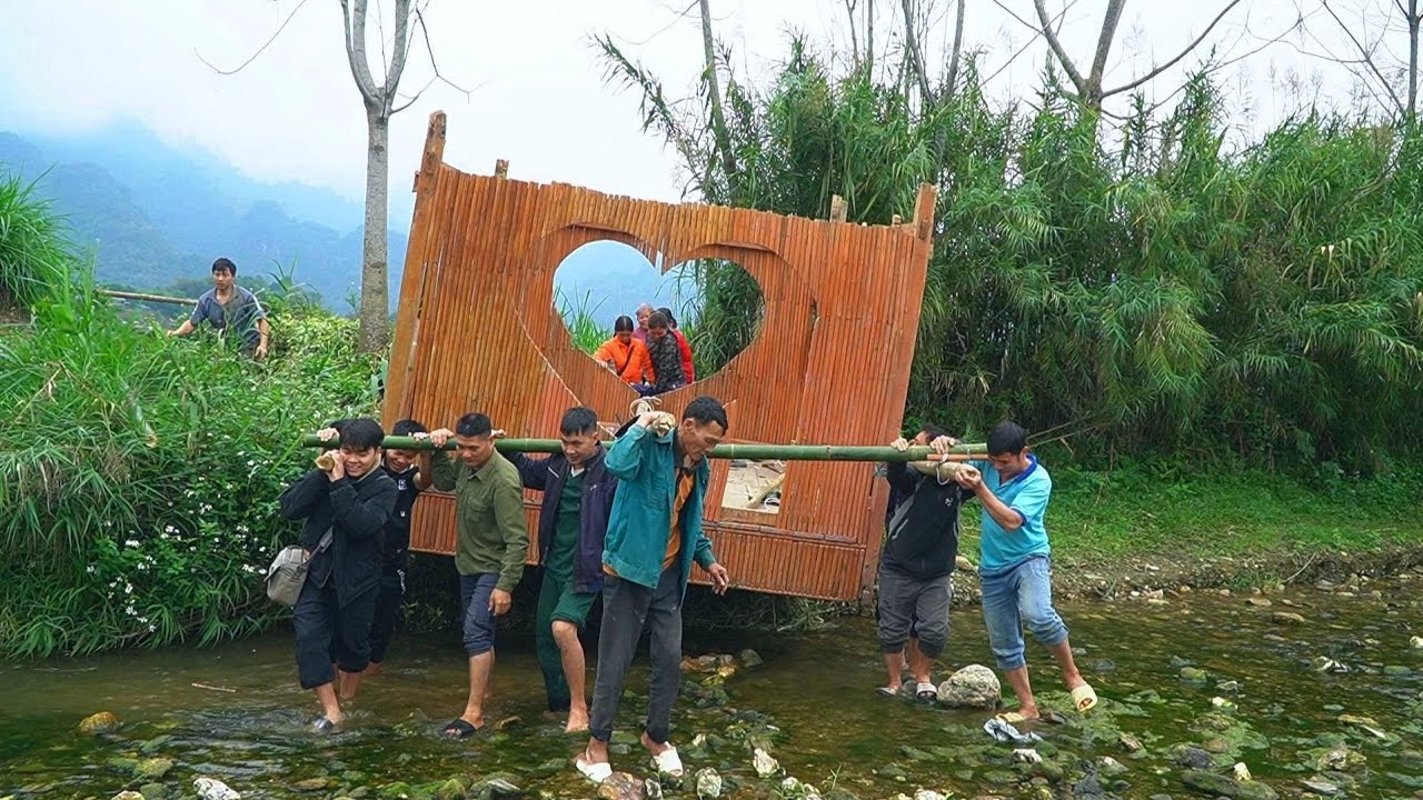 KONG NHAT, with the help of his neighbors, successfully transported the enormous shack.