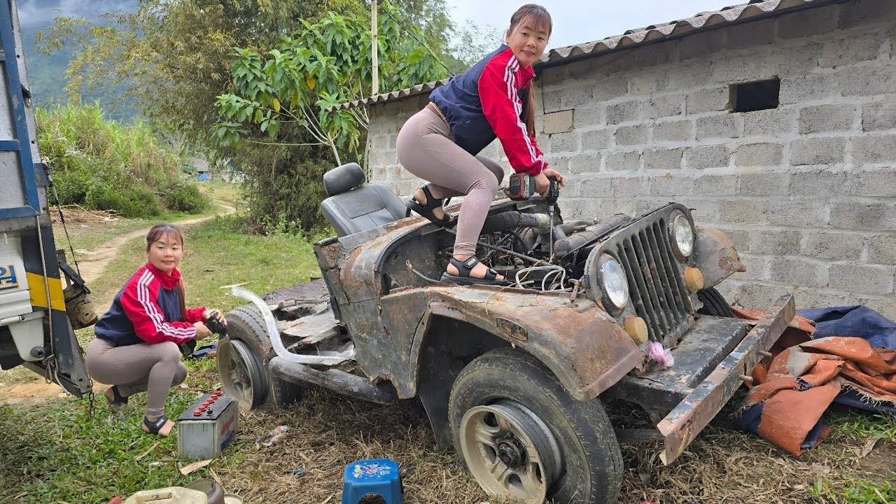 The girl repaired and restored the engine of a scrap JEEP car for her neighbor