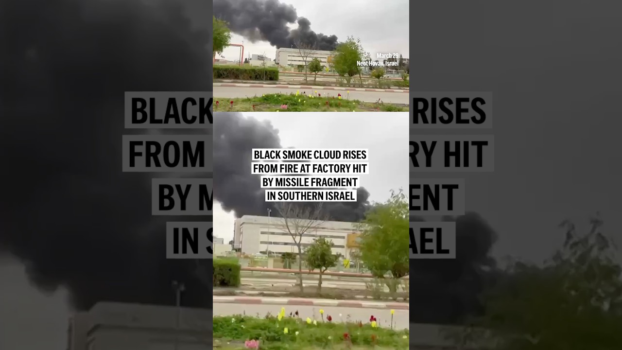 Black smoke cloud rises from fire at factory hit by missile fragment in southern Israel