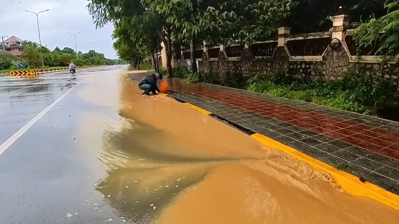 Water falls from the mountain when it is raining, flooding the road #unclogging #unclog #drain