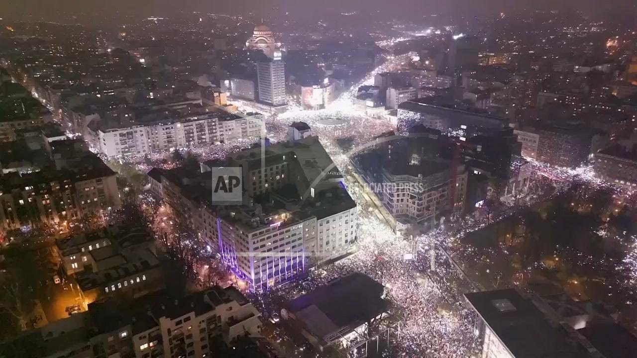 Phones glow in night air at silent anti-government protest in Belgrade
