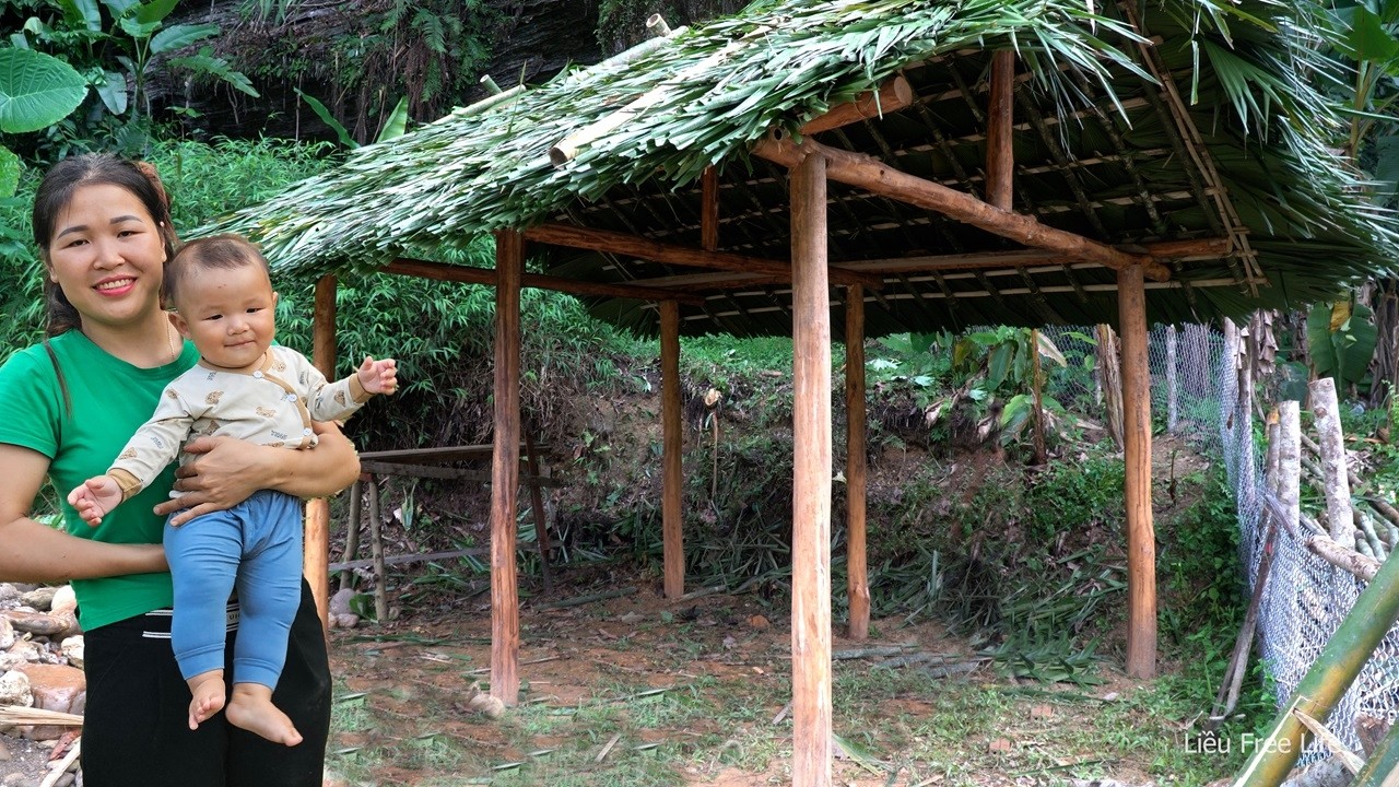 Building a pig feed cooking shed - Digging posts, laying thatched roof