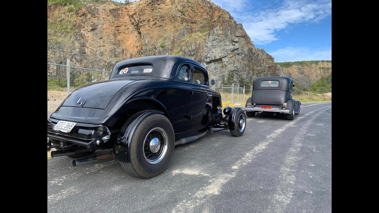 Hot rods cruising on a beautiful sunny day.