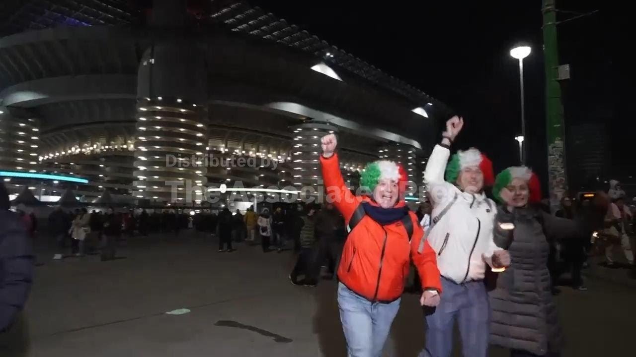Excited spectators react after the opening ceremony of the Milan Cortina Winter Olympics