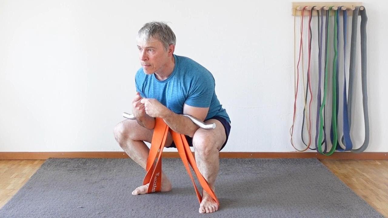 Get strong with resistance band zercher squats