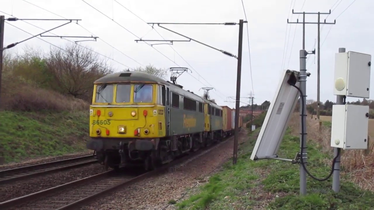 Freightliner class 86605 passes The Street pedestrian crossing in Belstead Ipswich Suffolk