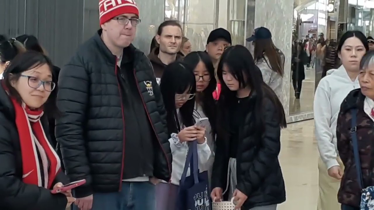 Chinese family standing by a Lunar New Year at Square One Shopping Centre Mall