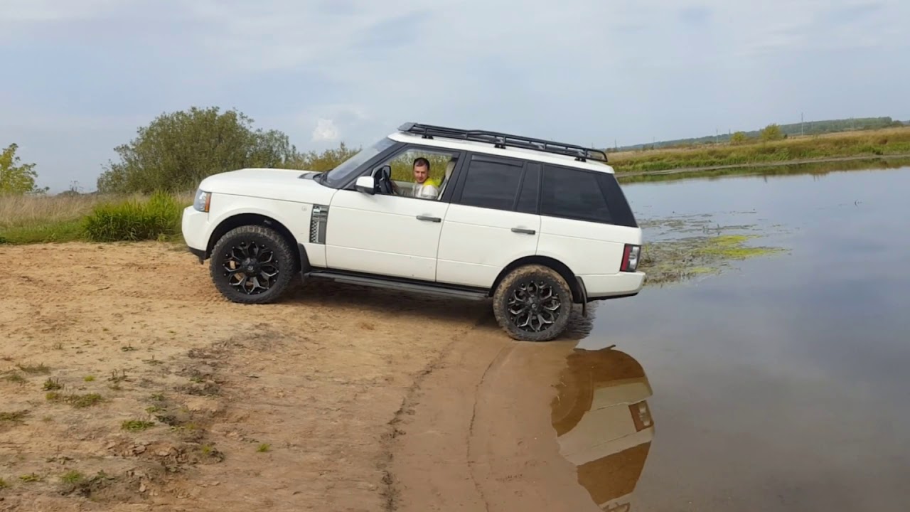Range Rover off-road in sand of river