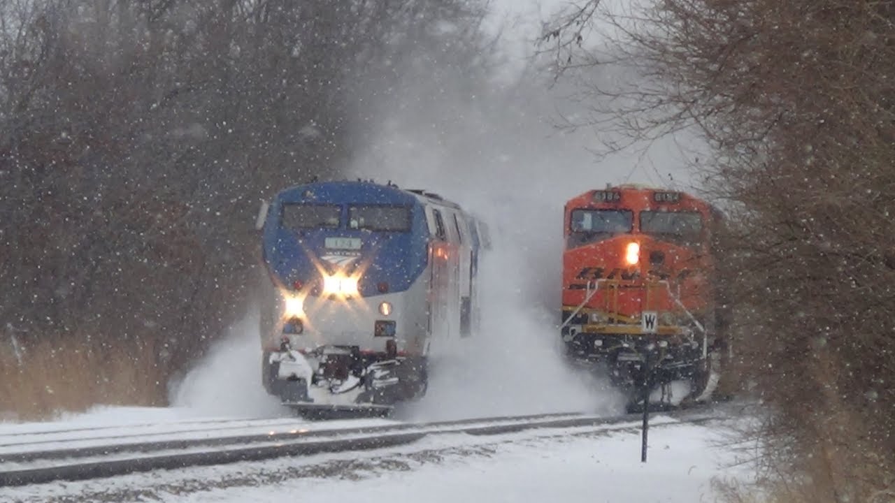 Slow BNSF Coal Train Gets Passed by Amtrak in Cloud of Snow