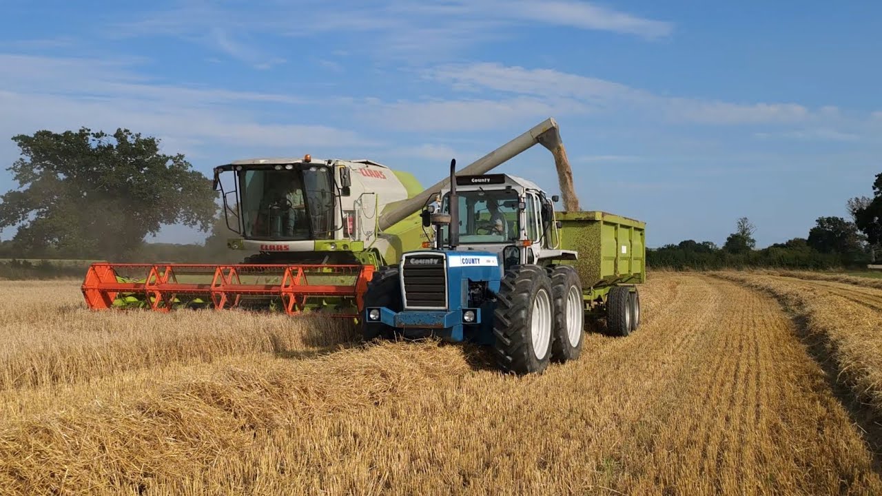 Claas Tucano 430 With a County TW 1184 & New Holland 8340 on hauling.
