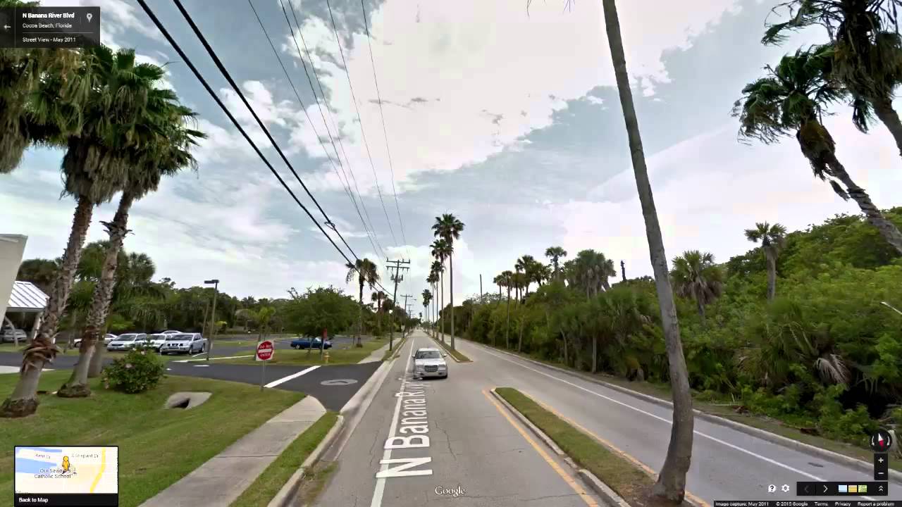 Street view of Cocoa Beach's historic palm tree lined boulevard before power company cut them down