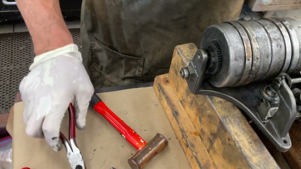 1995.  Removing the four spring barrels from a Columbia Grafonola phonograph motor.