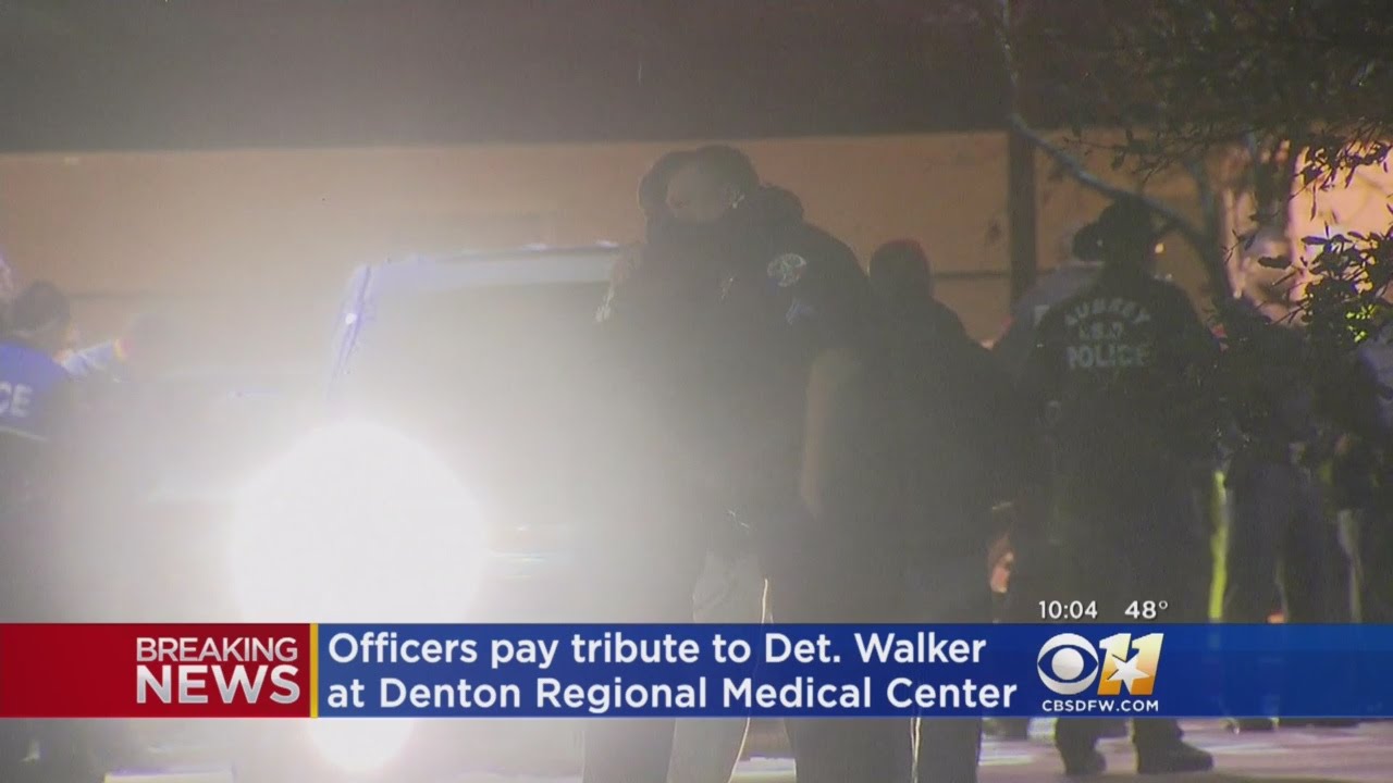 Police Officers Show Emotions Outside Denton Medical Center