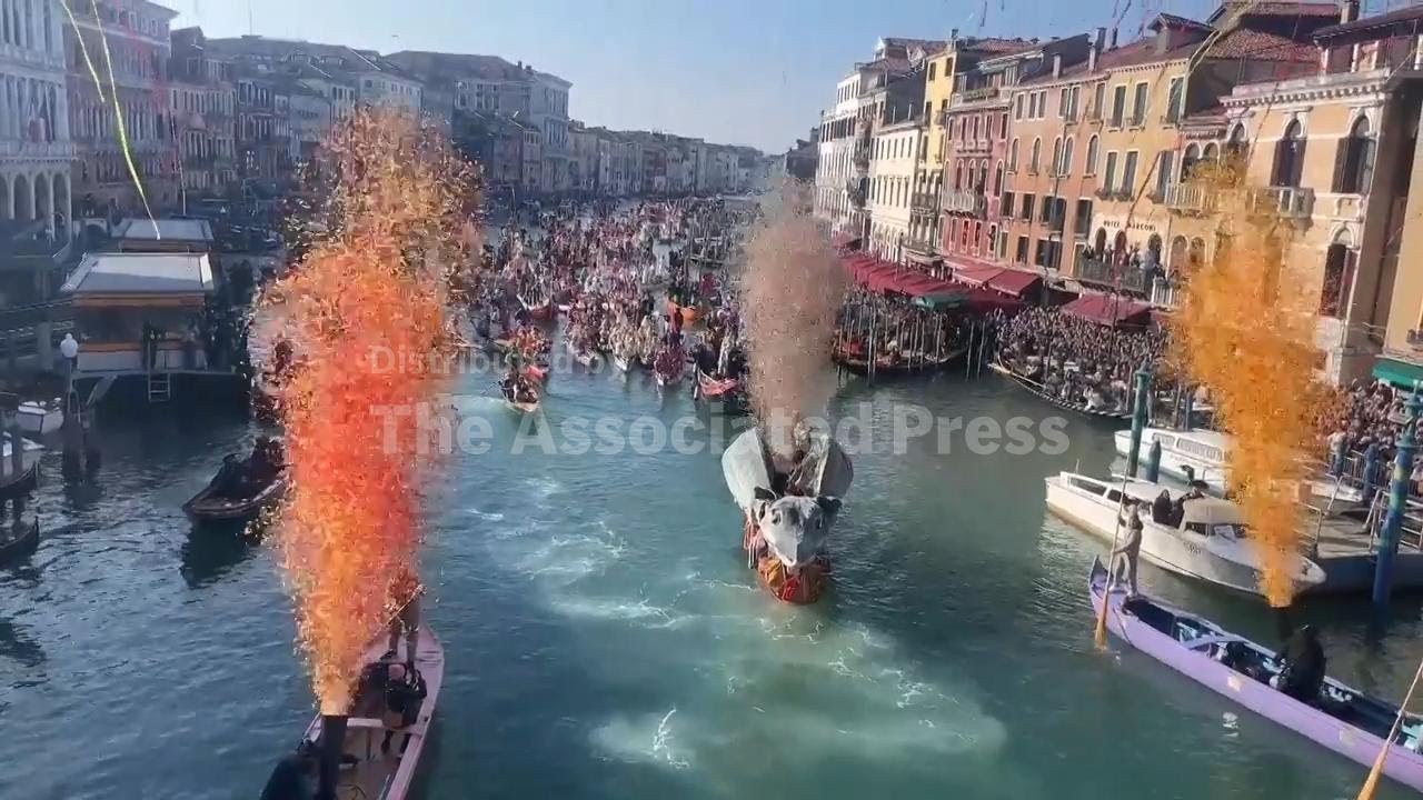 Dozens of boats bearing costumed participants sail along Venice's Grand Canal in Carnival parade