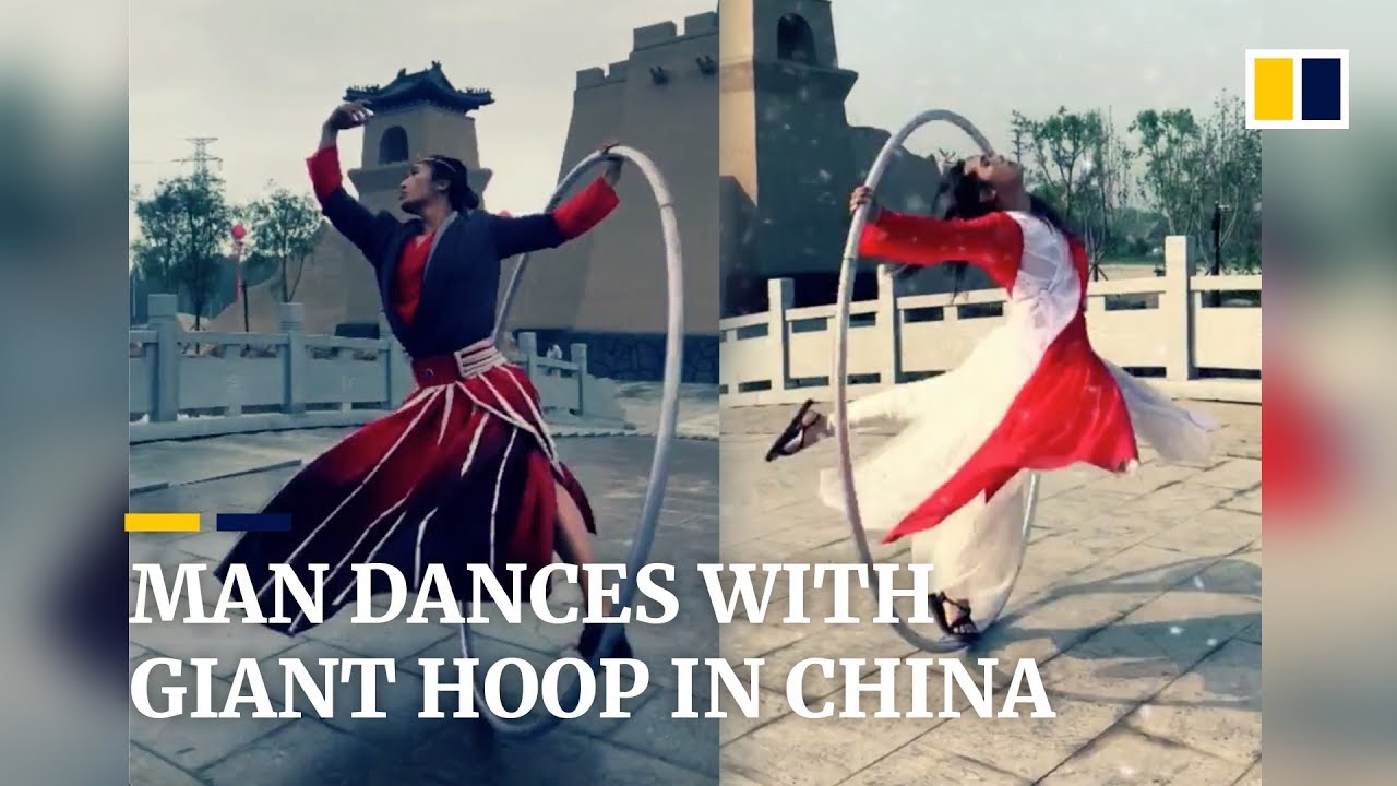 Man evokes ancient China as he dances with huge steel hoop