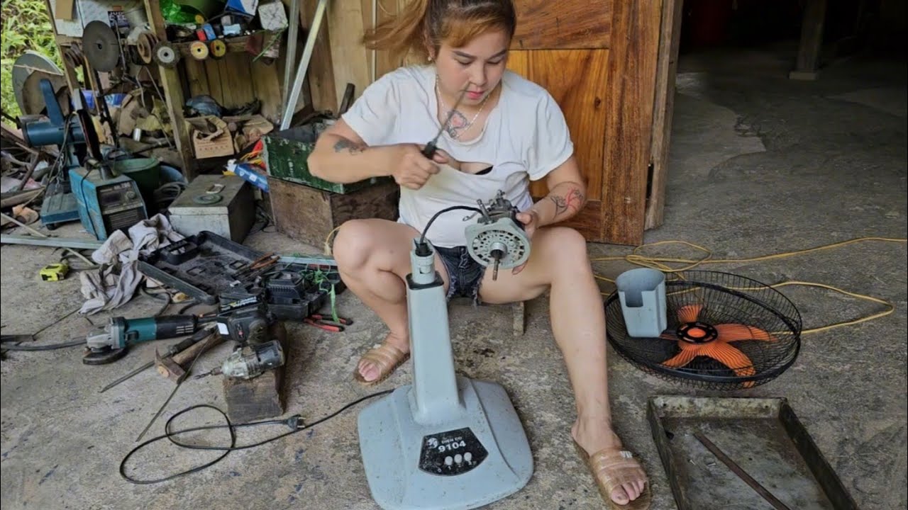The female mechanic repaired and restored a severely damaged electric fan.
