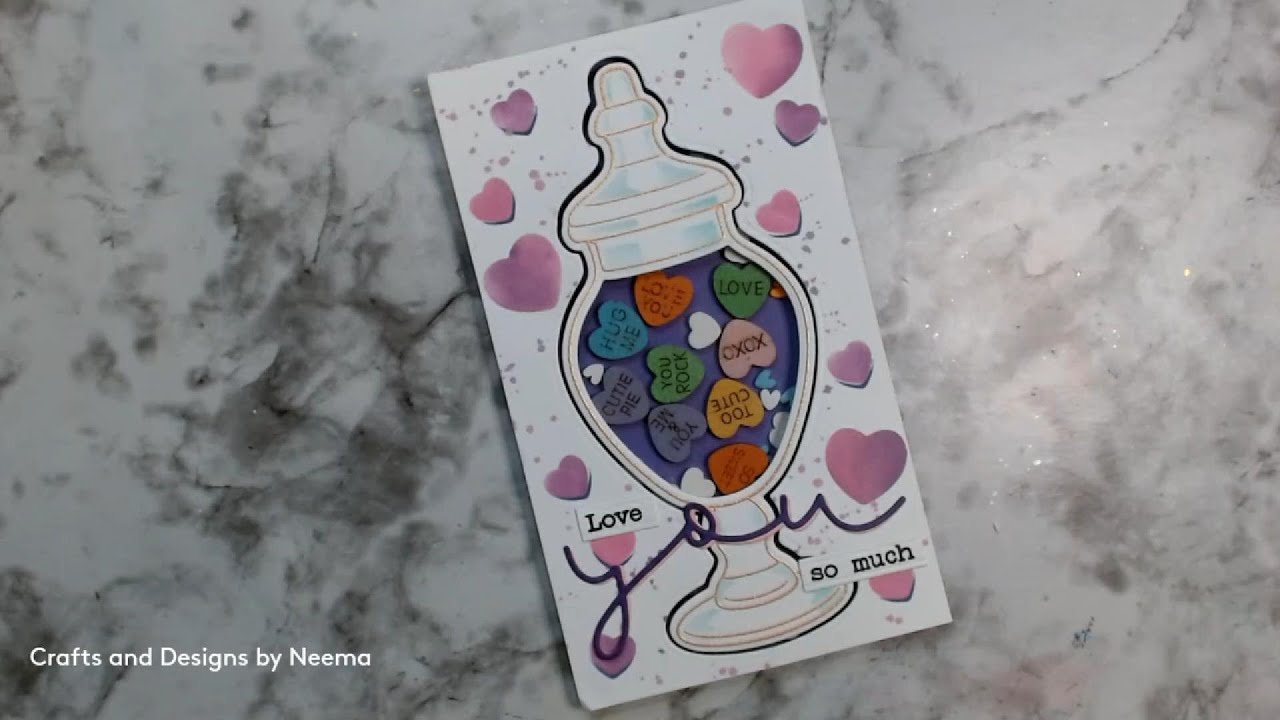 A  Shaker Jar filled with Valentine's candies. 