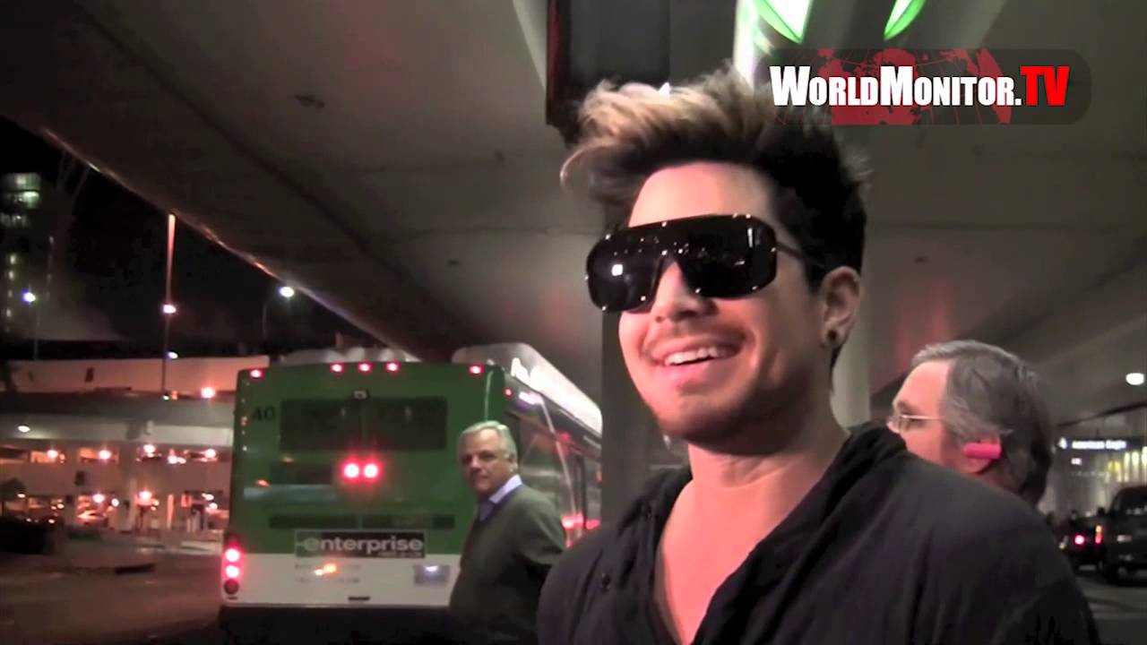Adam Lambert all smiles being questioned 3am by the paparazzi at LAX