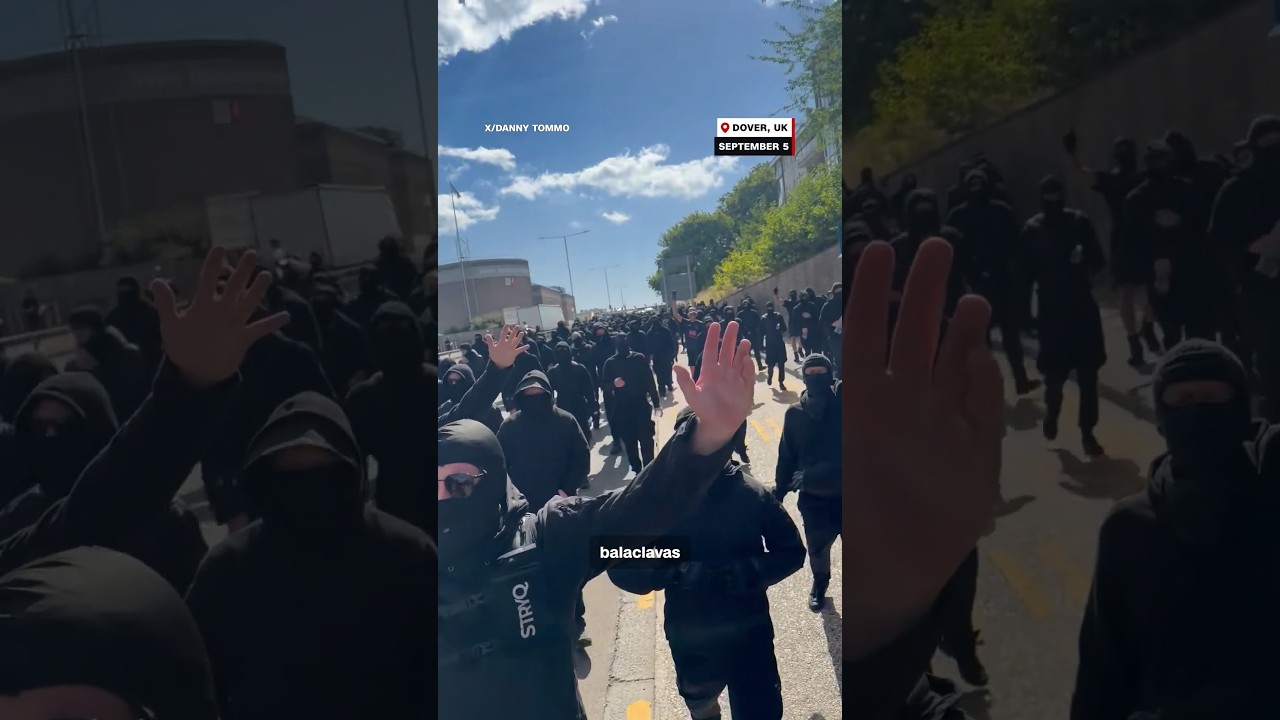 Masked men block roads in anti-immigration protest