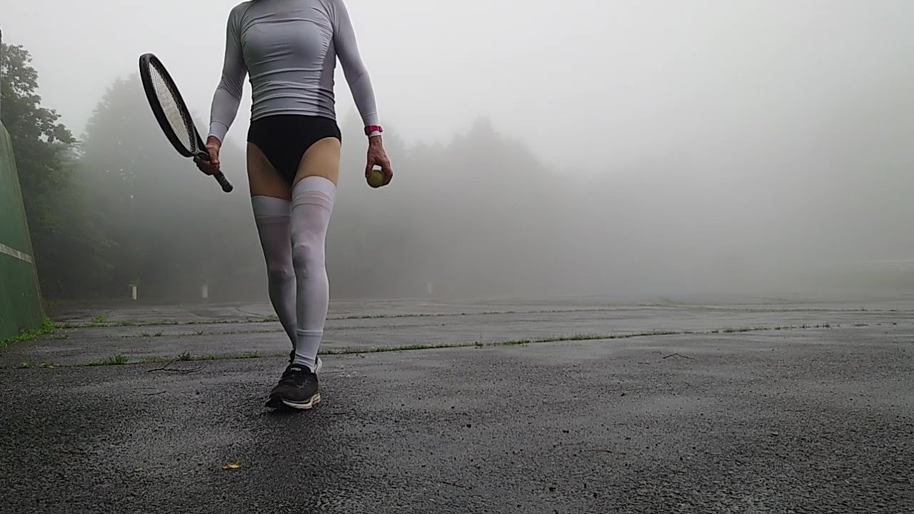 Tennis rally at the sports park in the fog