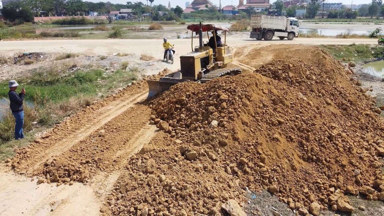 Skilled Operation in Action! 6-Wheel Dump Truck & Komatsu Dozer Powerfully Filling Flooded Land.