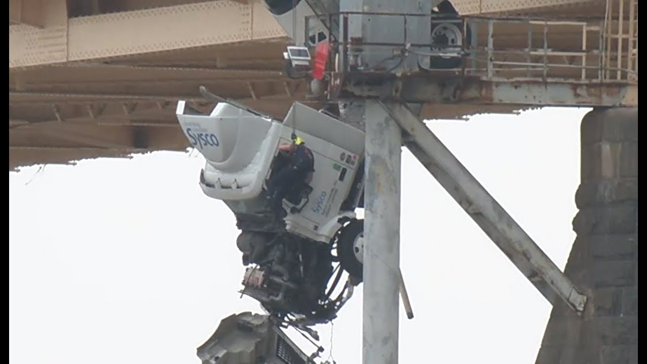 Rescue crews pull driver from semitruck hanging over Ohio River after collision on the 2nd Street
