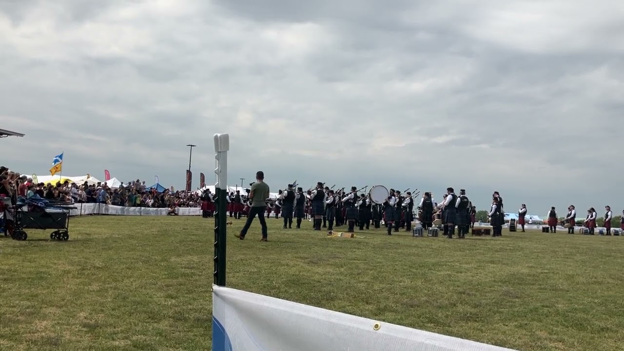 Highland powwow Scots playing and marching with bagpipes. 
