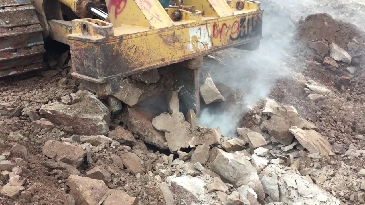 Caterpillar D8H dozer ripping through hard rocks!