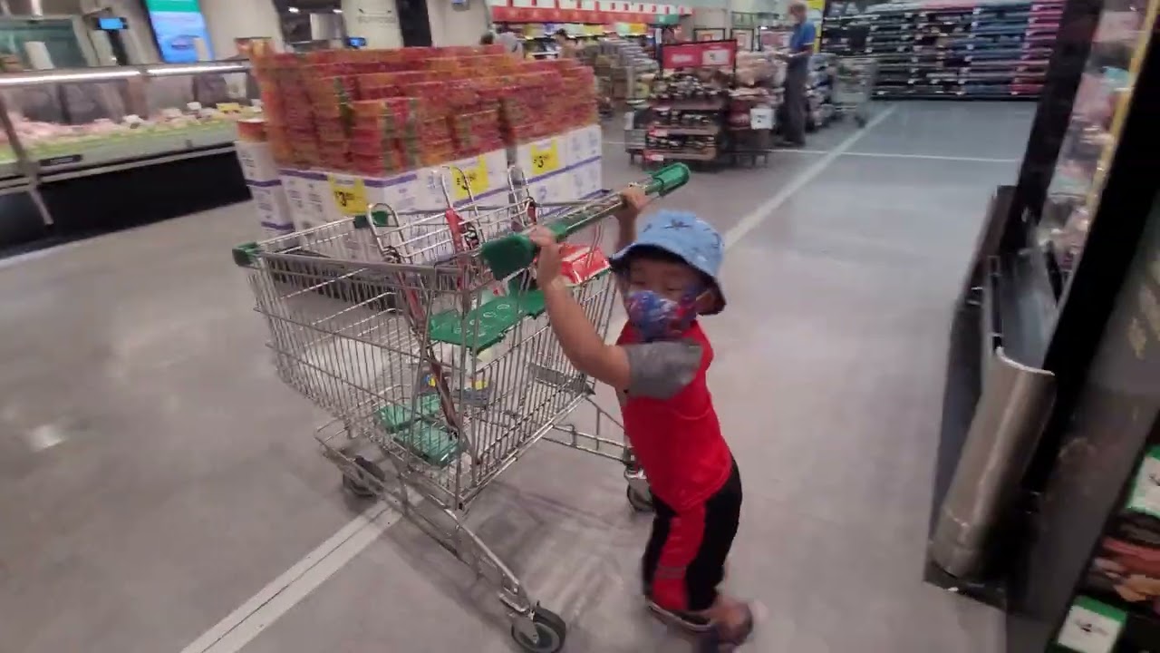 Helping mum pushing trolley in woolies