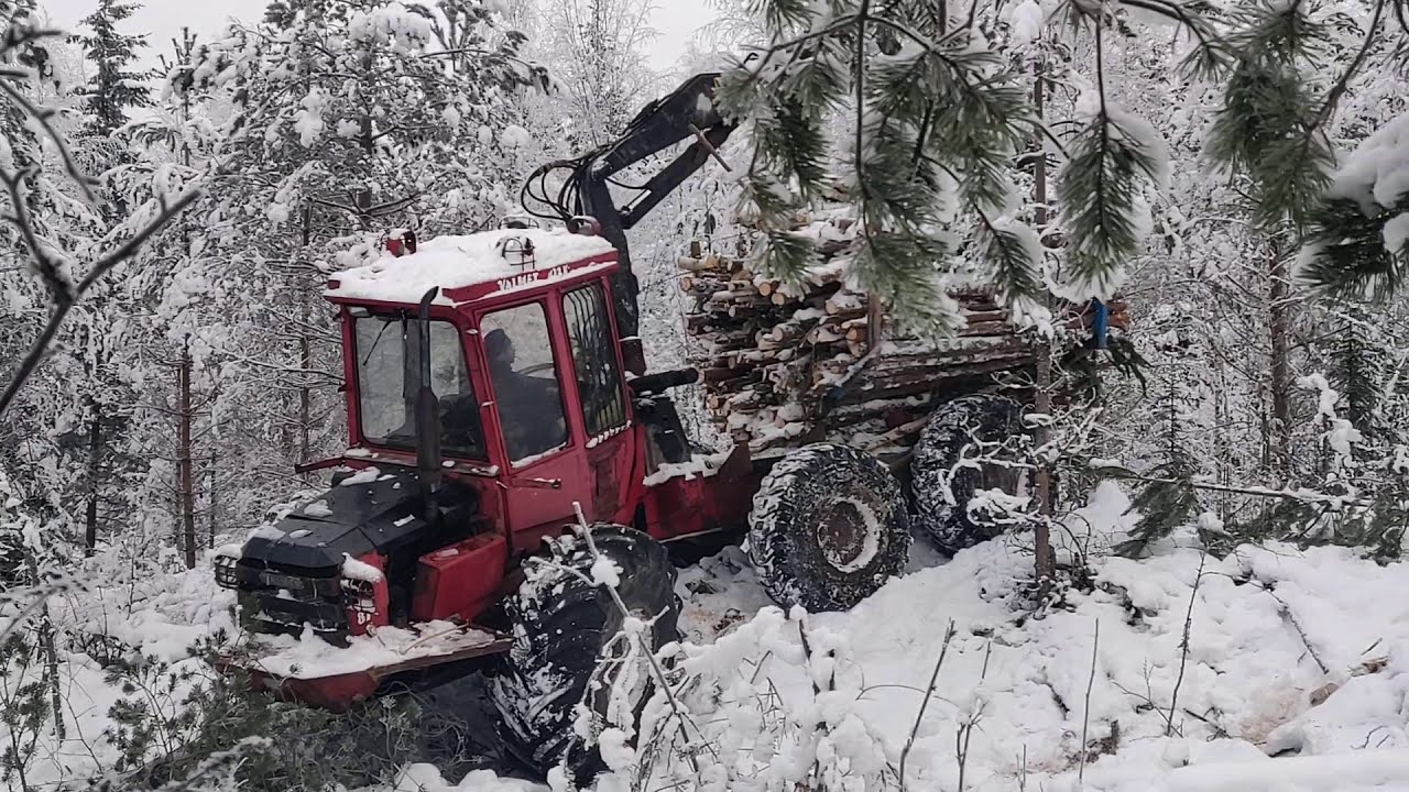 Valmet Forwarder in a snowy forest.