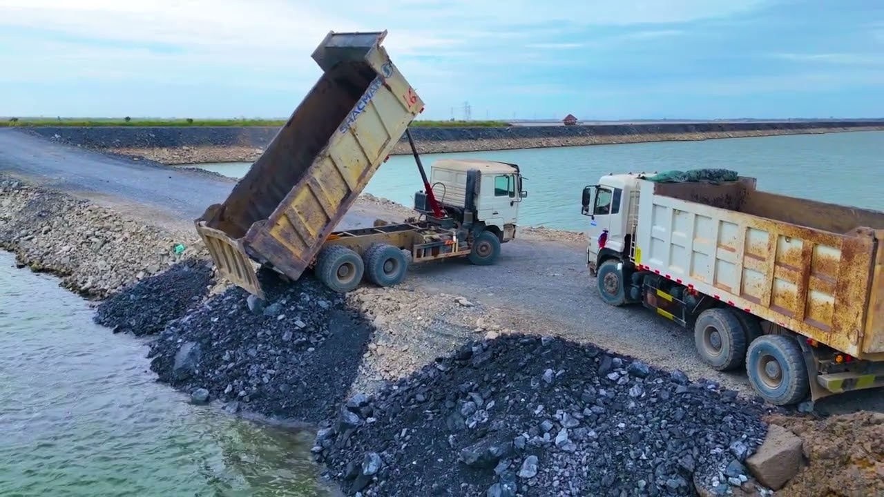 Full video of new project to dump truckloads of rock into a large lake use a lot of heavy machinery