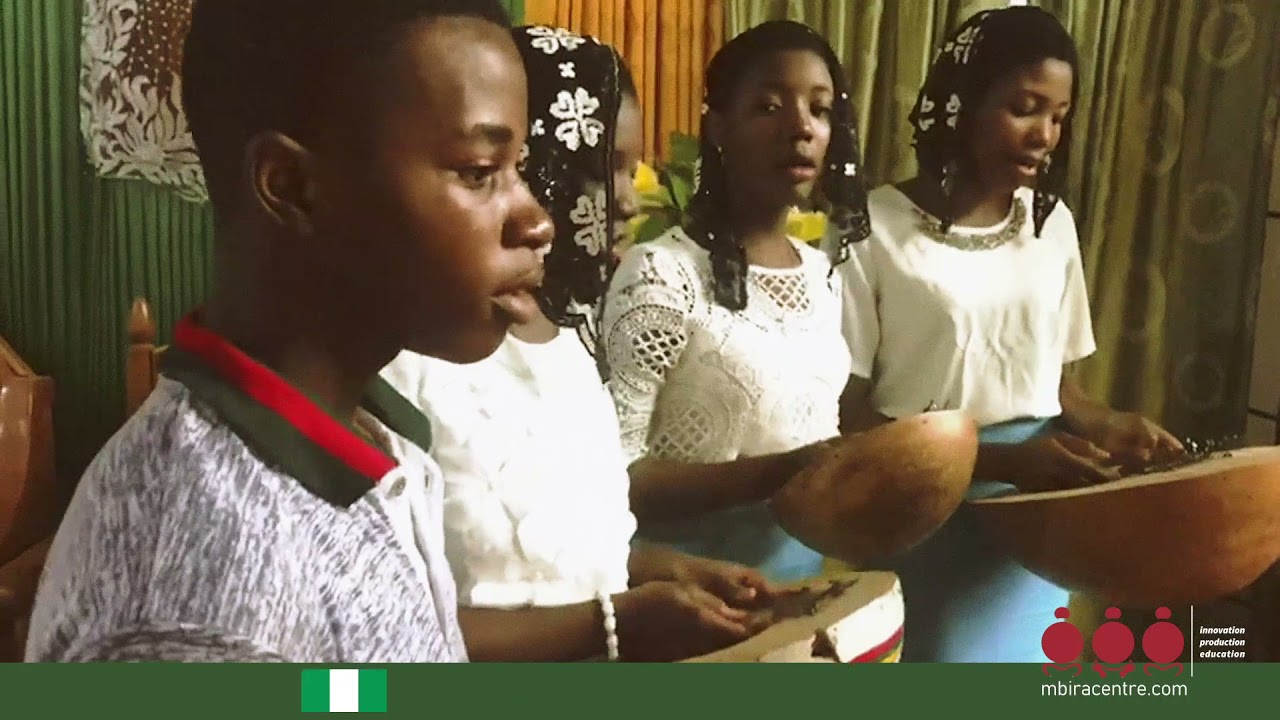 You Nigerians playng the Ubo, a Nigerian lamellophone.