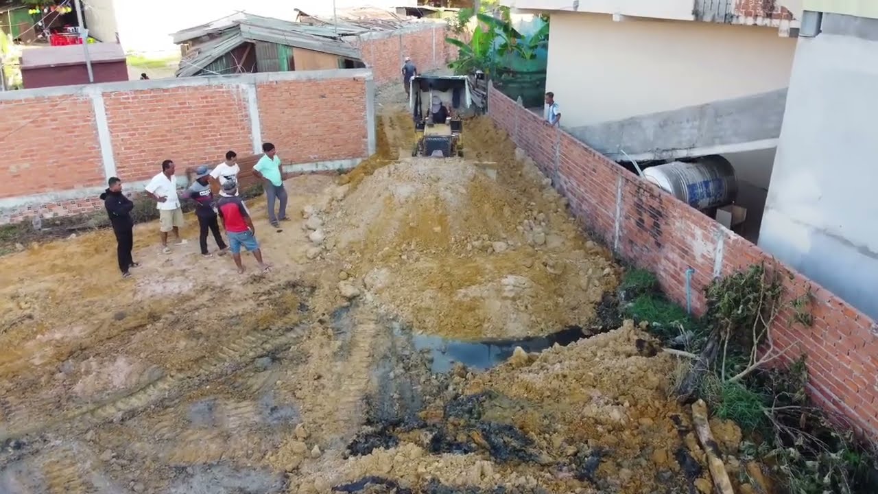 Burying garbage with a Komatsu D20p mini bulldozer quickly moves the soil apart