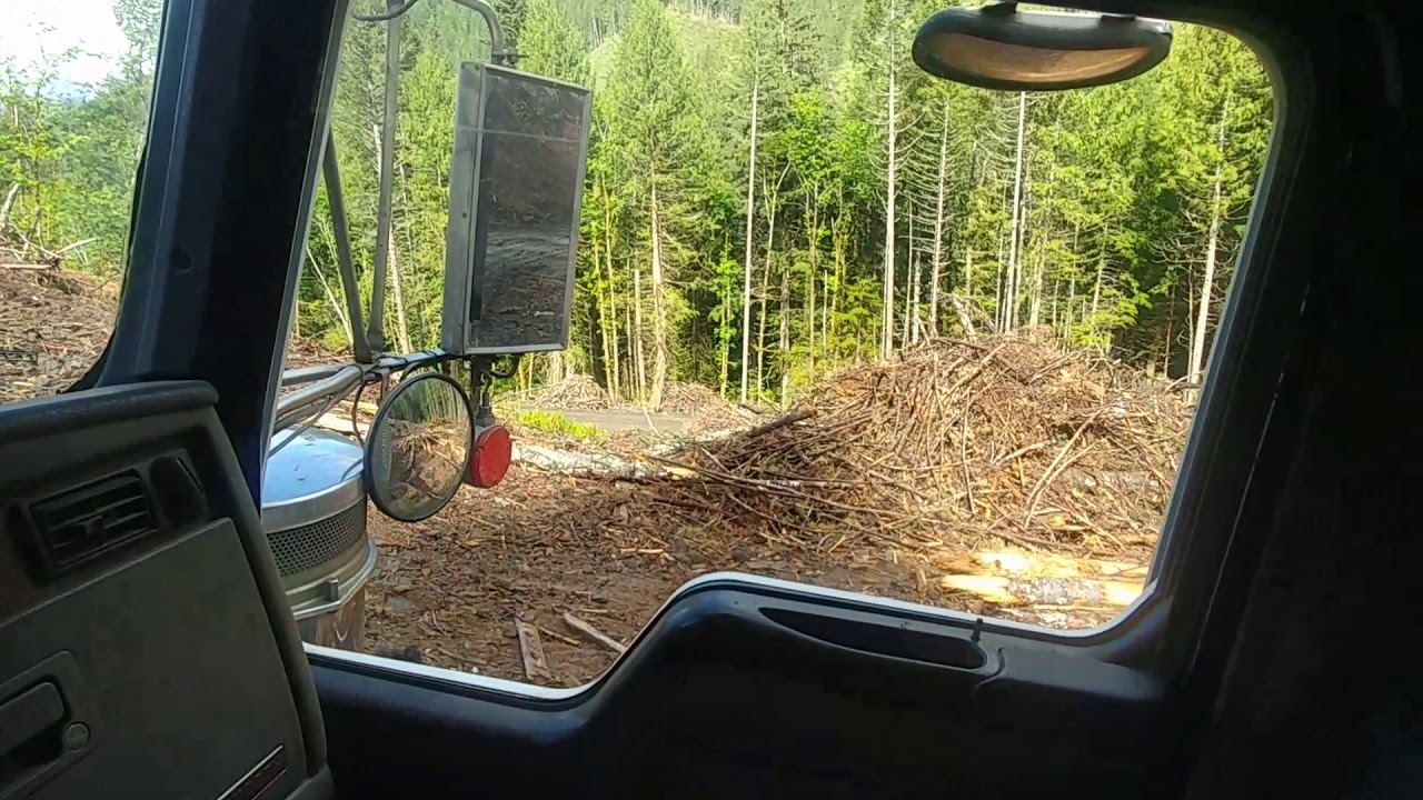 Log truck driving on the yarder side with a steep switchback