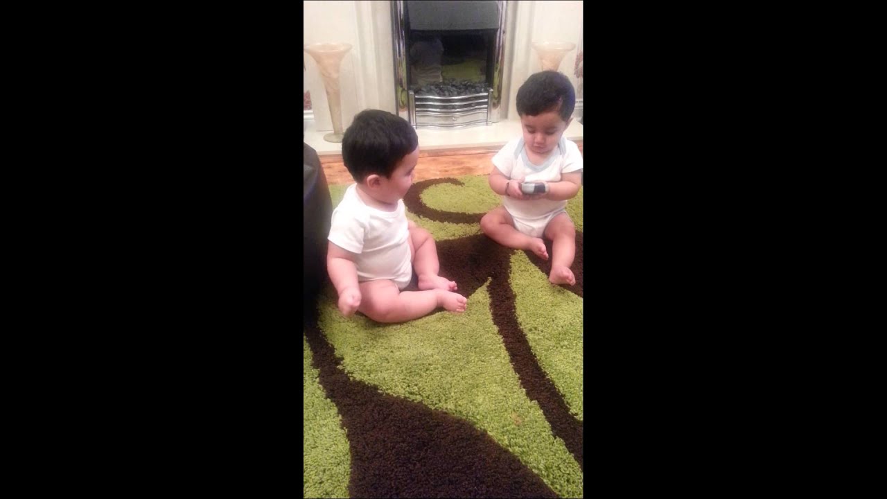 Twin brothers fighting over a remote