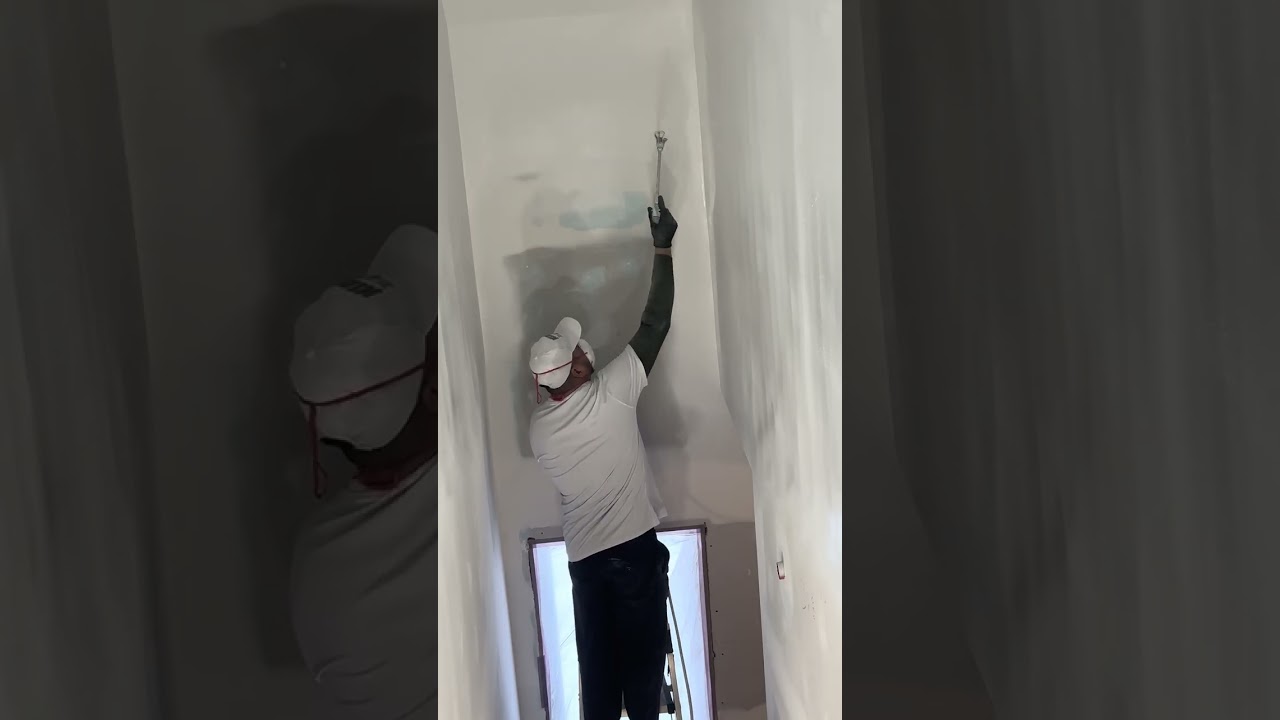 Spraying process of praimer and painting on drywall walls for a professional, clean finish, 