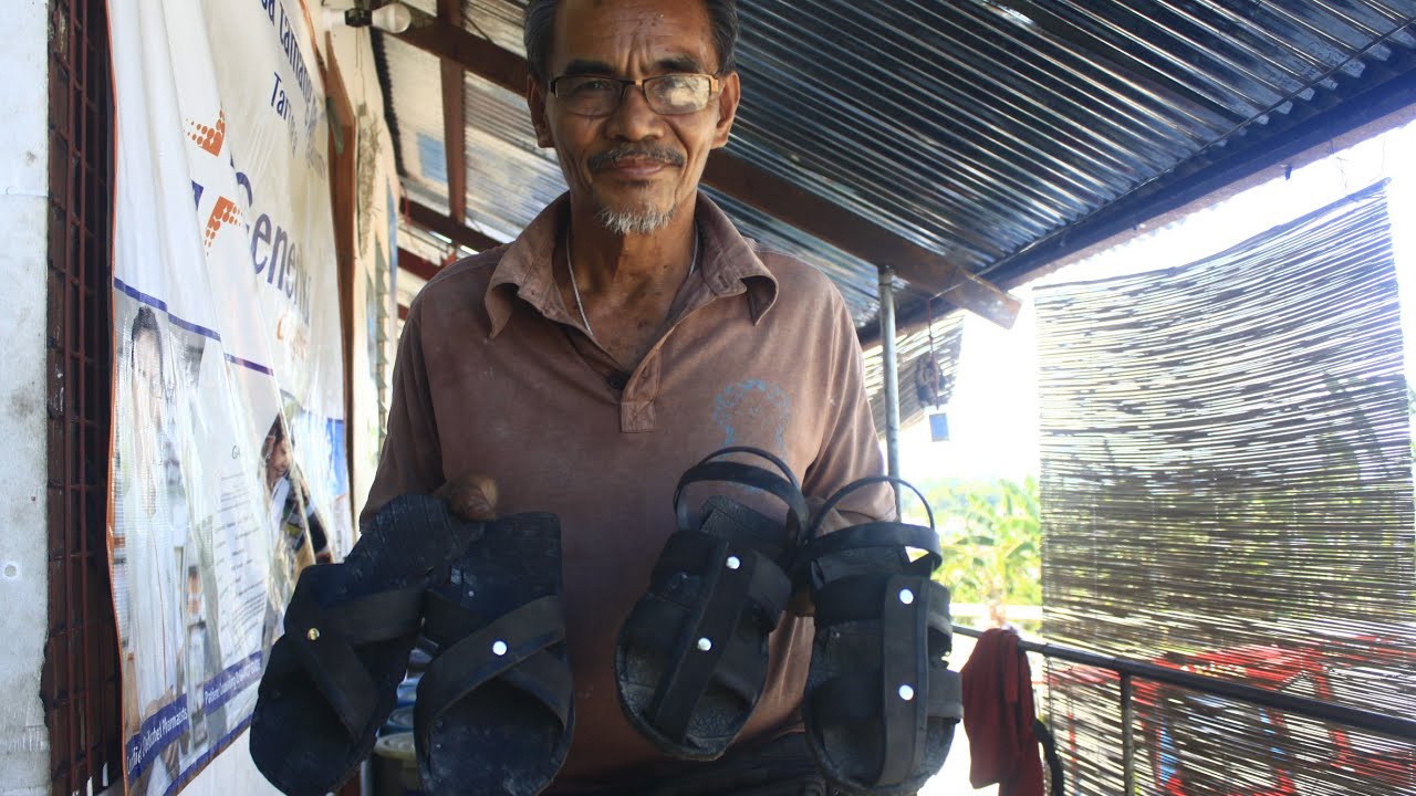 Turning old car tires into survival sandals (san-goma sandals) made in san carlos city