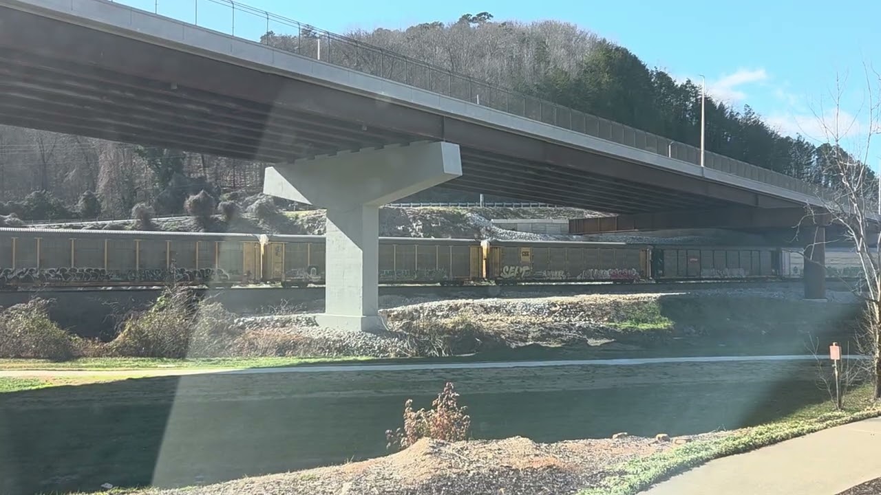 Northbound graffiti train under the new bridge by the Greenway 