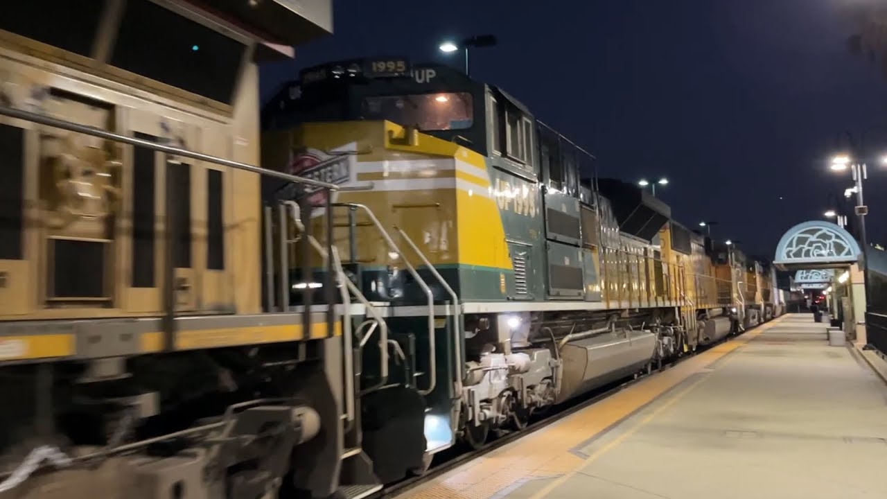 UP 1995 trails on the ZMQLA passes Montebello station after dark.