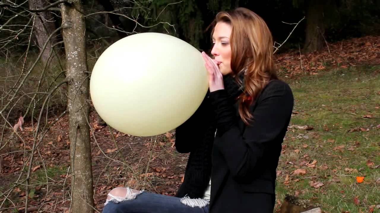 Miki blowing up a huge balloon - clips4sale.com/studio/45940
