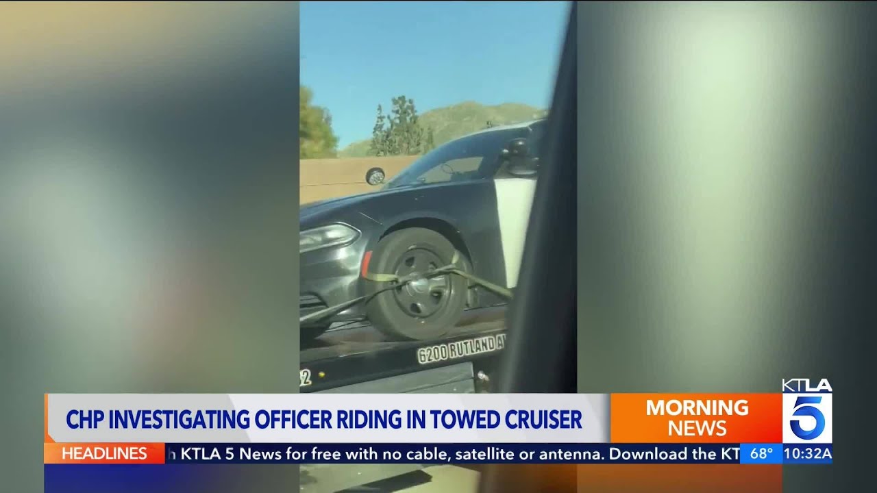 CHP investigating officer seen riding in towed cruiser on freeway