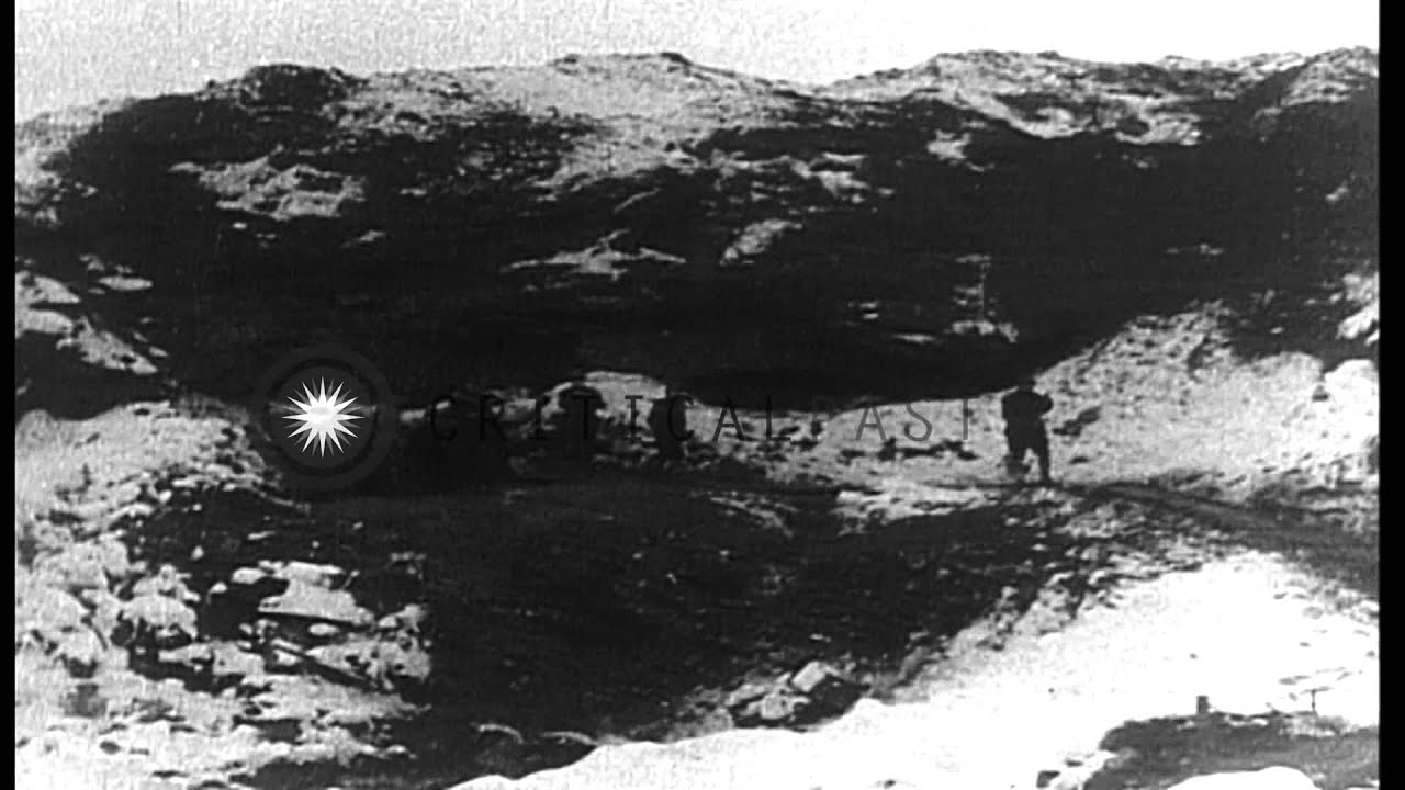 Men walk on the destroyed battlefield at Fleury, Douaumont near Verdun, France. HD Stock Footage