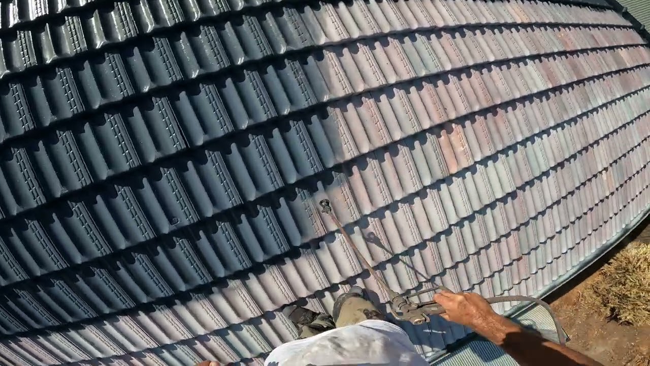 Applying Heat Reflective Roof Membrane To Terracotta Roof Tiles In Charcoal