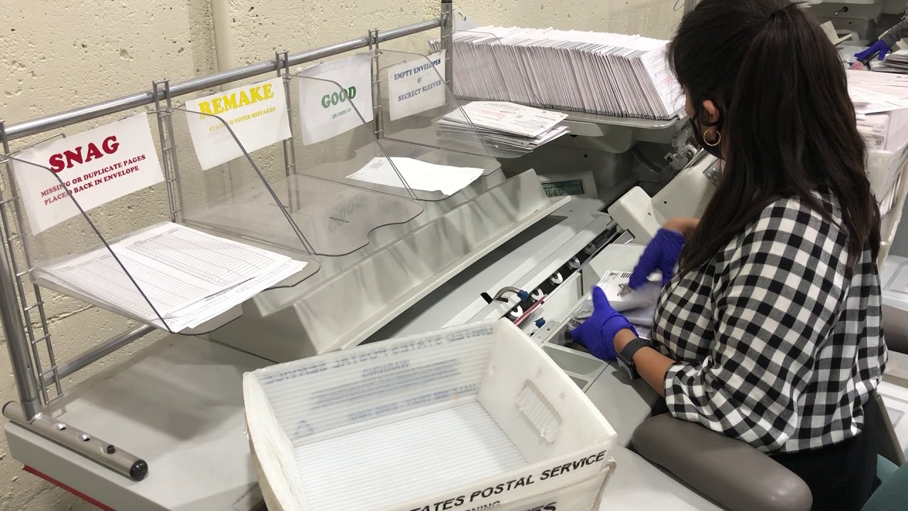 cutting open ballot envelopes