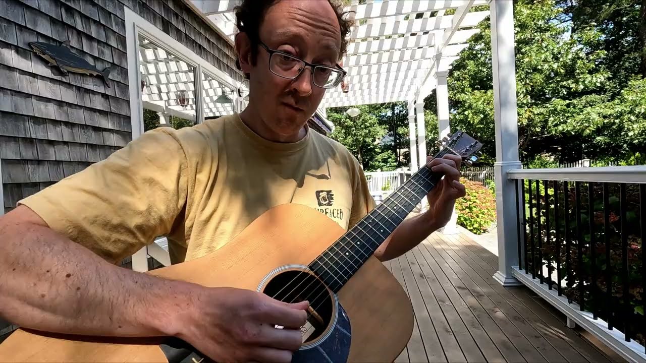 Acoustic guitar practice session on a nice porch day