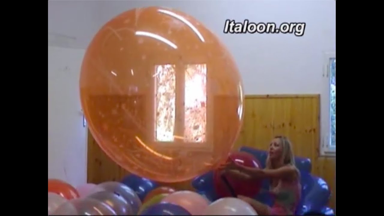 Gaia Pumps To Pop A Giant Orange Balloon