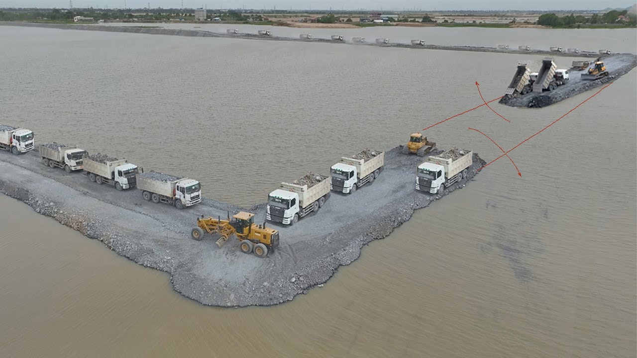 Excellent Skill With Hard Work of Dumping Rock Into Deep Water To Connect by Dump Trucks And Dozer