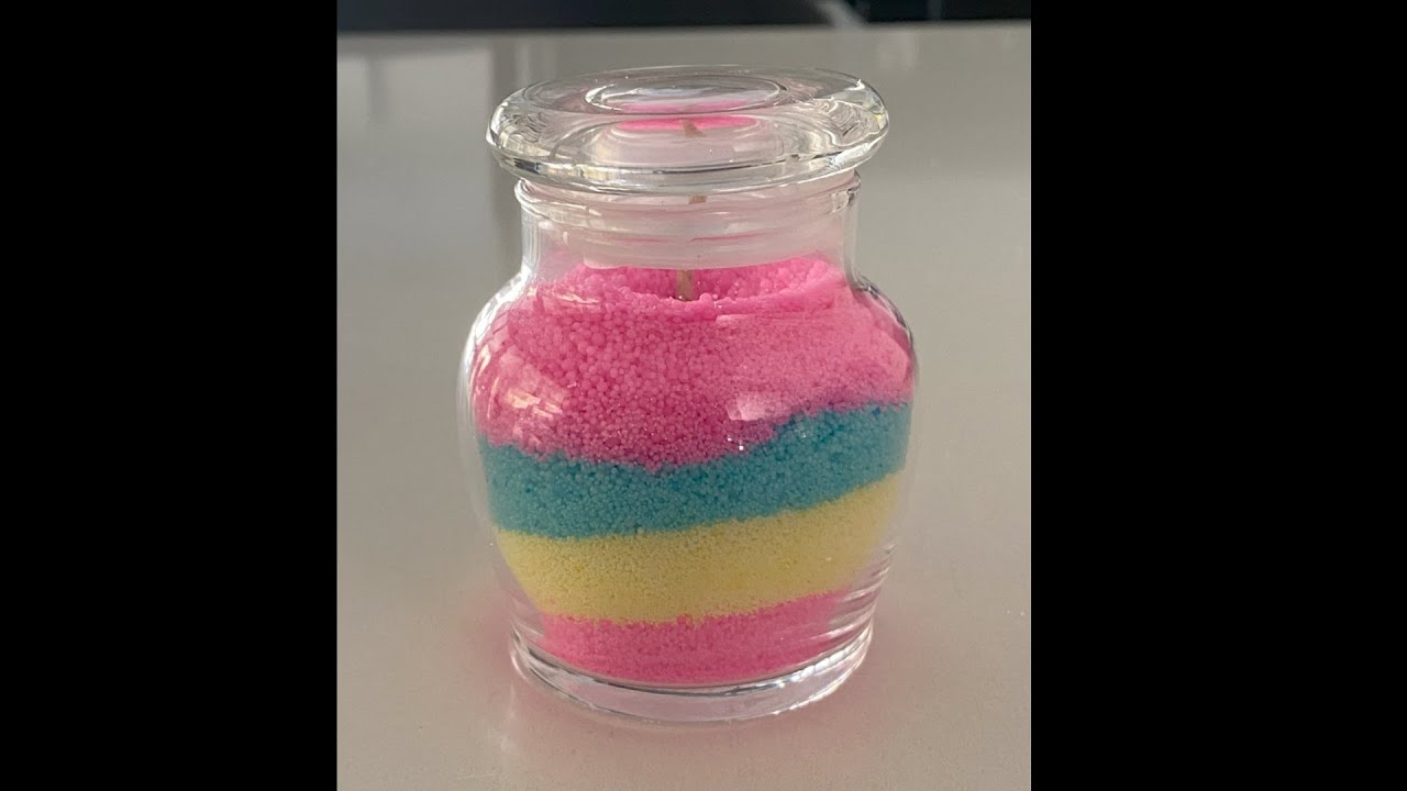 Making a sand candle - with white and coloured wax