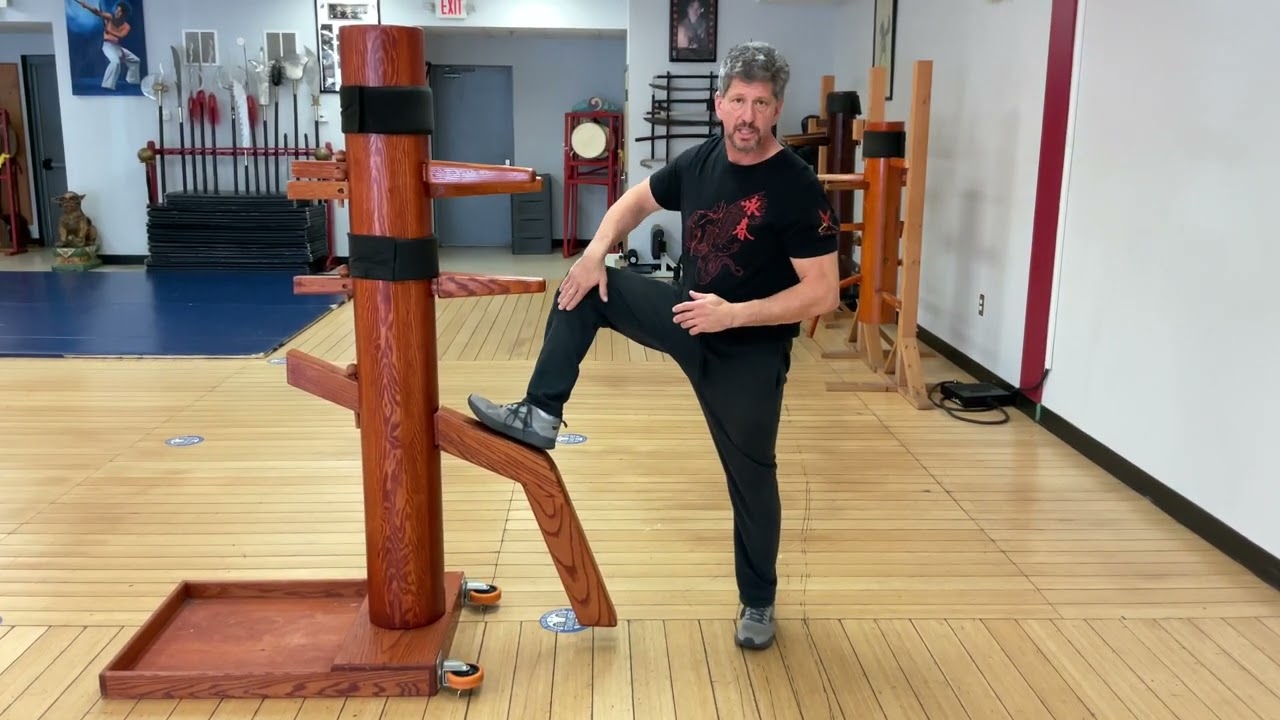 Wooden Dummy utilizing  the Wooden Dummy to practice round kick defense